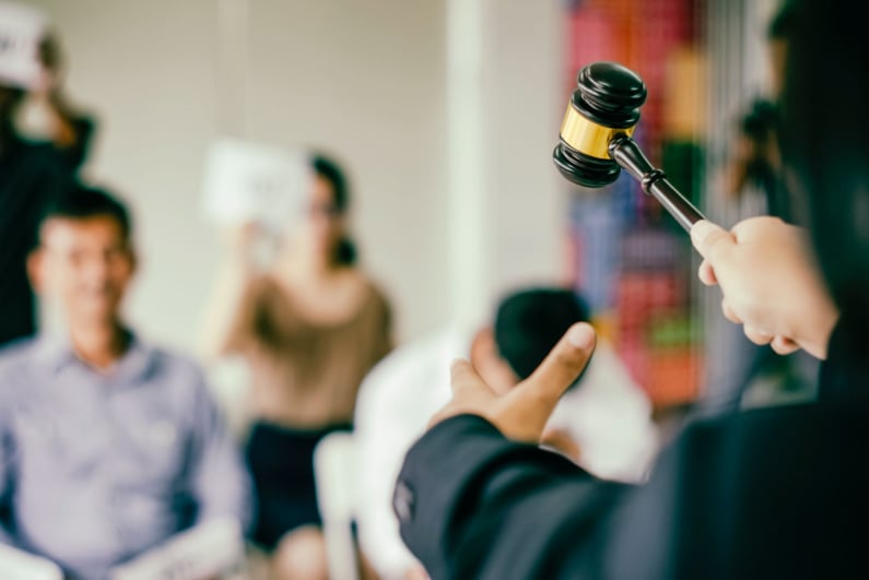 Auctioneer raising hammer